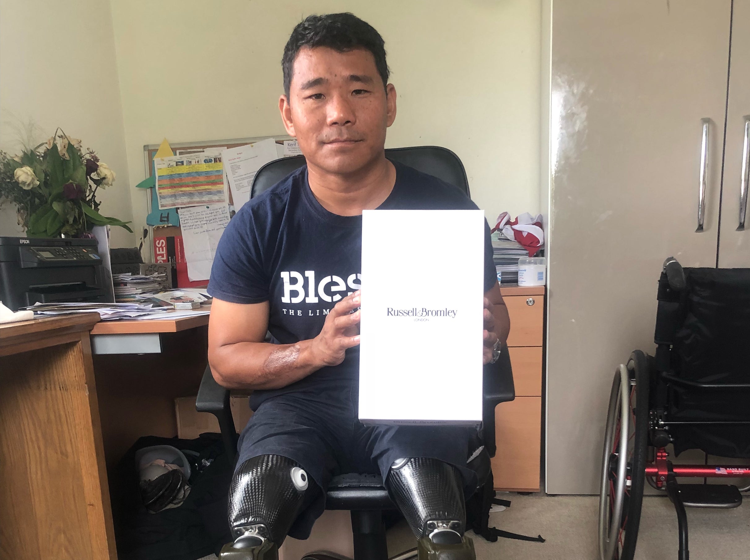Hari Budha Magar receives his new shoes from Russell and Bromley